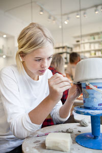 Girl making pottery