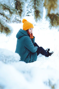 Young beautiful woman in winter forest with fir trees person