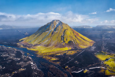 Scenic view of volcanic mountain against sky