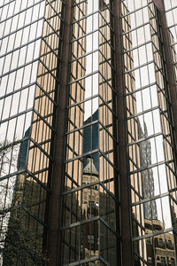Low angle view of building seen through glass window