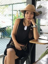 Portrait of woman sitting at table in restaurant