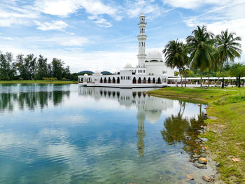 Scenic view of lake by building against sky