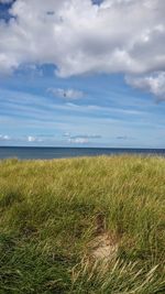 Scenic view of sea against cloudy sky