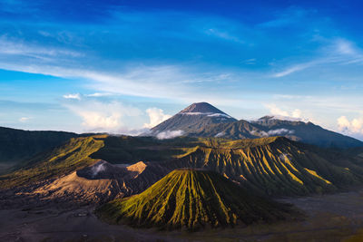 Scenic view of mountain range against cloudy sky