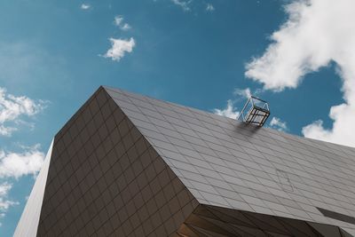 Low angle view of building against cloudy sky