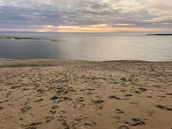 Scenic view of beach against sky during sunset