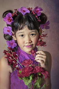 Portrait of cute girl with pink flower