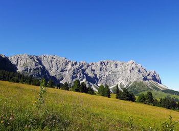 Scenic view of mountains against clear blue sky