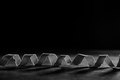 Close-up of design on table against black background