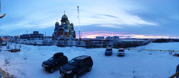 View of snow in city against sky