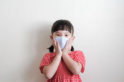 Portrait of teenage girl against white background