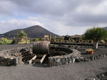 Stack of rocks on landscape against sky