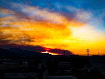 Silhouette buildings against sky during sunset