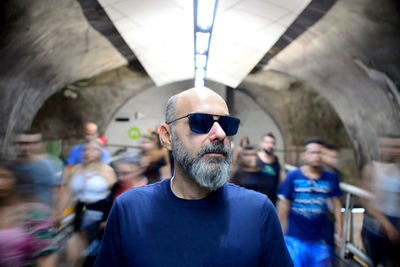 Mature man standing at subway station