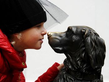 Close-up of girl touching statue