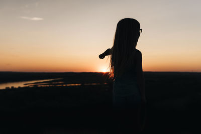 Little girl watches sunset overlooking missouri river in bismarck north dakota