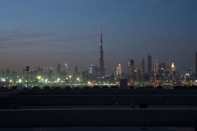 Illuminated city against sky at night