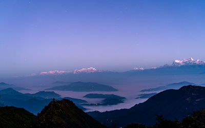 Scenic view of mountains against blue sky