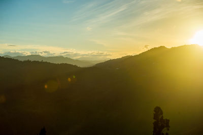 Scenic view of silhouette mountains against sky at sunset