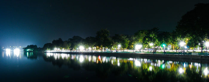 Scenic view of lake against sky at night