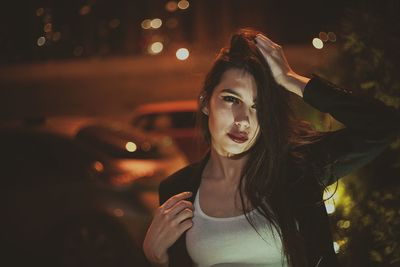 Portrait of young woman at night