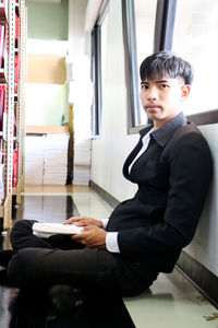 Portrait of young businesswoman sitting in train