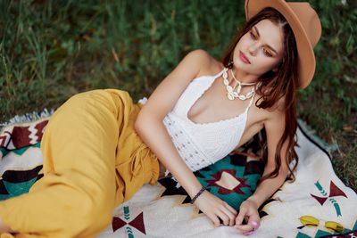 Young woman sitting on sofa at park