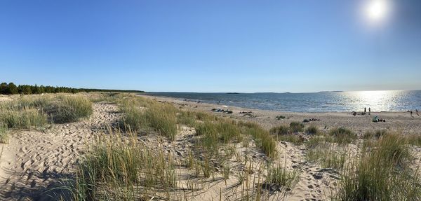 Scenic view of sea against clear blue sky