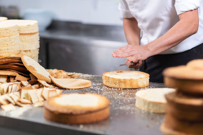 Midsection of man preparing food in kitchen