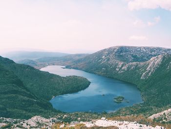 High angle view of river amidst mountains against sky