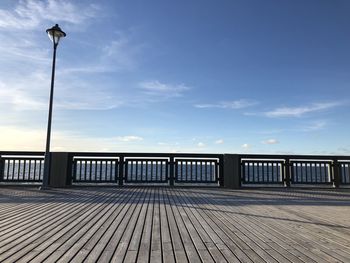 Street by pier against sky