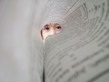 Portrait of girl through paper