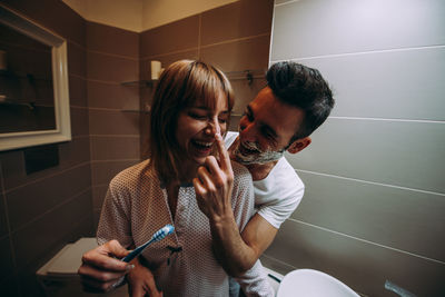 Couple having fun in bathroom at home