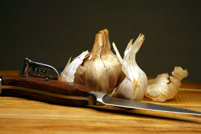 Close-up of bread on table against black background