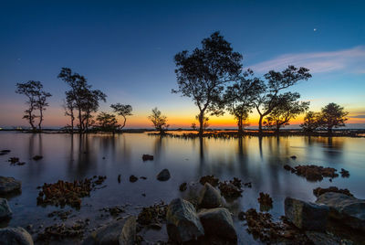 Scenic view of lake against sky during sunset