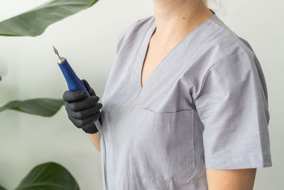 Midsection of man holding syringe