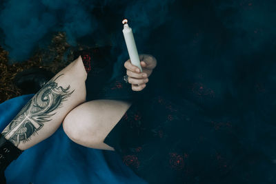 High angle view of woman smoking cigarette