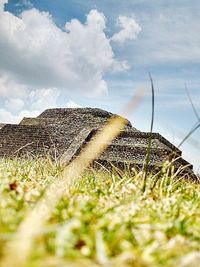 Scenic view of field against cloudy sky