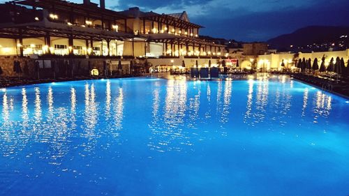 Reflection of illuminated built structure in water