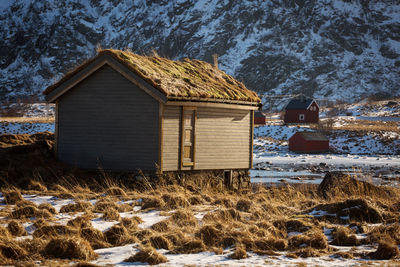 House on field against mountain