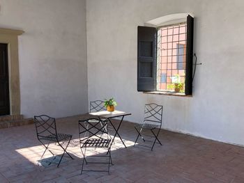 Empty chairs and table in building