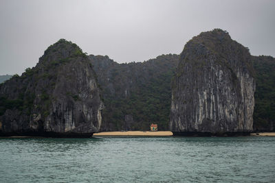 Scenic view of rock formation in sea against sky in ha long bay, vietnam