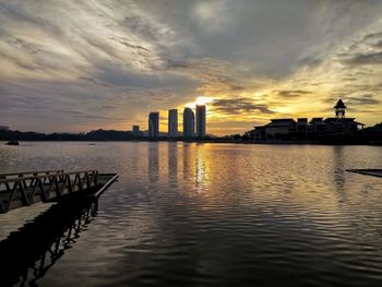 View of city at waterfront during sunset