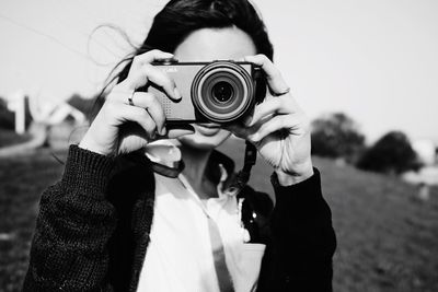 Young woman holding camera