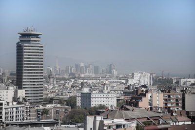 Buildings in city against clear sky