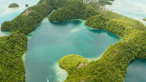 Cove and blue lagoon among small islands covered with rainforest. sugba lagoon, siargao, philippines