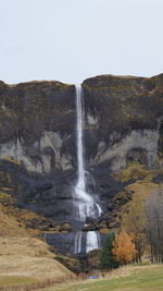 Scenic view of waterfall against sky