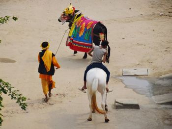 Rear view of people walking outdoors