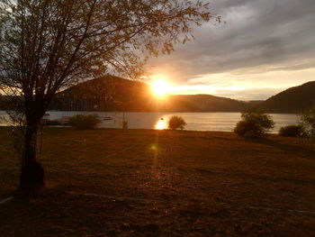 Scenic view of lake against sky during sunset