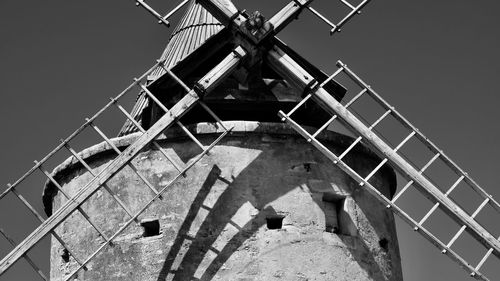 Low angle view of traditional windmill against clear sky